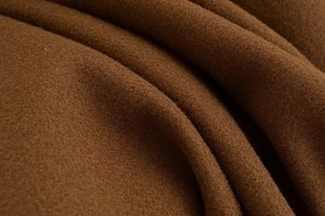 Detailed macro view of high-quality dark brown wool fabric texture on a short coat