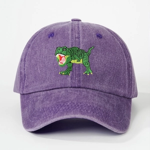 Detailed close-up of green dinosaur embroidery on washed cotton purple baseball cap