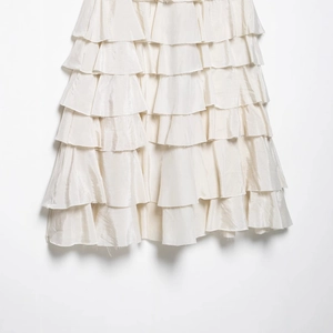 Elegant multi-layered cream white tiered long skirt with a subtle glossy finish