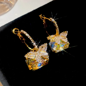 Macro view of gold plated butterfly earrings featuring square colorful cubic zirconia
