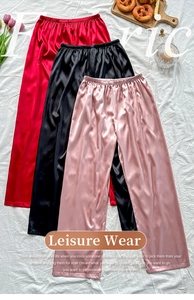 Three colors of silky lounge pants including red, black, and pink with elastic waist