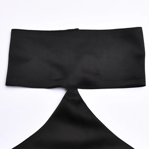 Detail of black satin fabric showing a unique cutout design and glossy silk texture