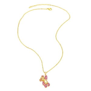Close-up of golden bear pendant necklace with sparkling pink cubic zirconia stones