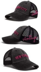 Detail of vintage washed mesh trucker hat with pink New York City embroidery