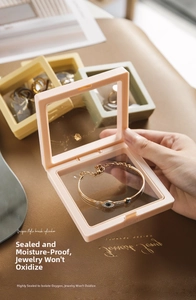 Macro detail of anti-oxidation PE film jewelry boxes with a bracelet inside on leather