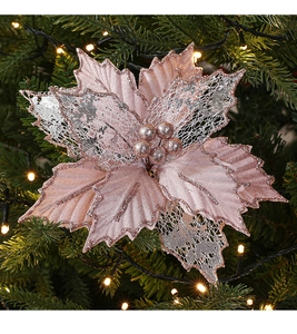 Close-up of rose gold artificial Christmas flower with glitter lace on tree
