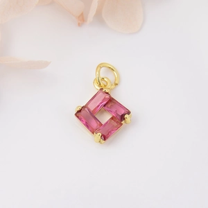 Macro shot of square pendant with four pink trapezoid zircons and gold-plated copper link