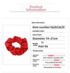 Detail showing red satin silk scrunchie dimensions 10-21cm with smooth fabric texture