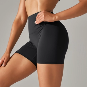 Detail of high-waisted black yoga shorts showing the squat-proof elastic fabric and fit