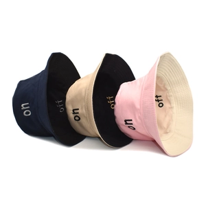 Three cotton fisherman hats in navy, beige, and pink with stylish letter embroidery