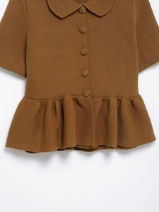 Close-up of brown knit cardigan featuring a Peter Pan collar and ruffled hem details
