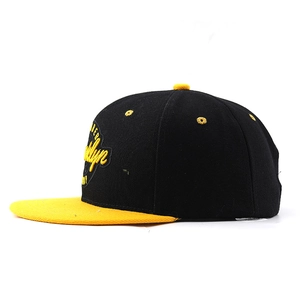 Détail de la broderie Brooklyn sur une casquette snapback hip-hop noire et jaune