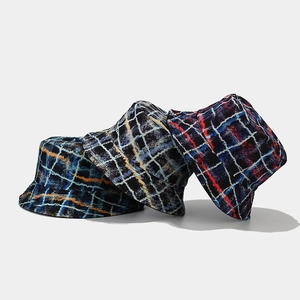 Three colorful graffiti plaid bucket hats in blue, orange and red on gray background
