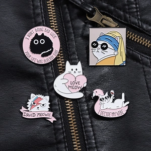 Detailed close-up of 5 creative cat enamel pins pinned onto a black leather biker jacket