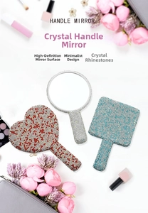 Close-up of crystal-encrusted heart and round handle mirrors with sparkling rhinestone detail