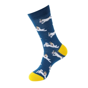 Detail of blue cotton crew socks featuring white dog patterns and yellow heel accents