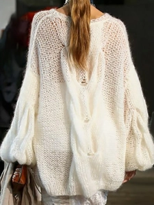 Back view of women's oversized white cable knit sweater with chunky openwork texture