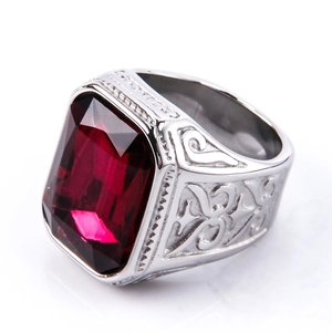 Detailed close-up of large red rectangle gemstone and engraved silver steel ring