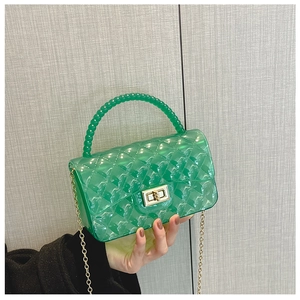 Detail of green transparent jelly bag featuring diamond quilted texture and gold hardware