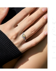 Macro detail of crown ring with pear-shaped yellow gemstone and pave set diamonds on hand