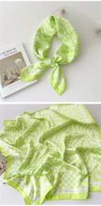 Detail of lime green and white checkered satin scarf with elegant knot and silky drape