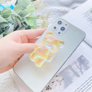 Close-up of iridescent 3D bear phone grip on mobile back in lifestyle setting