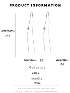 Detail view of long silver tassel star earrings showing 24.7cm length and alloy material