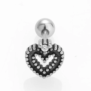 Macro detail of a vintage heart stud earring with clear zircon and grainy texture