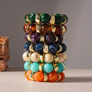 Chunky acrylic resin bracelets in assorted marble patterns with golden metal spacers