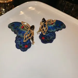 Asymmetric embroidered butterfly stud earrings with colorful rhinestones and gold-tone metal