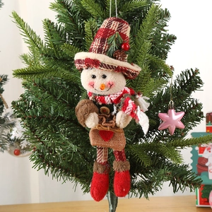 Knitted snowman Christmas tree ornament with plaid hat and scarf hanging on a festive tree