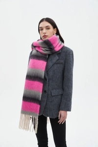 Detail of pink and grey gradient striped scarf with thick fringe tassels on a model