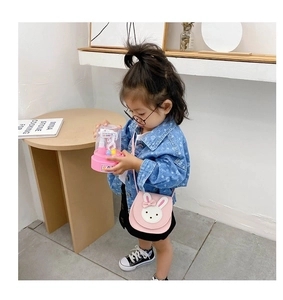 Detailed view of pink toddler crossbody bag with cute bunny patch and bow detail