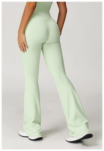 Side-back view of high-waisted flared yoga pants in light mint green with slimming fit