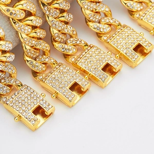 Macro detail of iced-out gold Cuban link chains with shimmering pave-set crystals