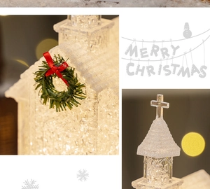 Close-up of lighted Christmas church ornament with green wreath and festive bokeh