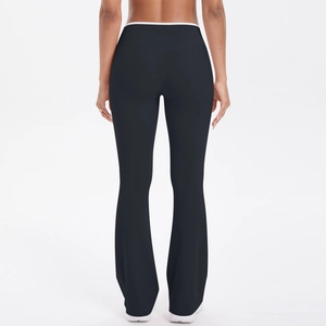 Detail view of high waisted black flare yoga pants with white contrast waist trimming