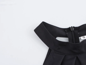 Detail of halter neckline with ruched fabric and size S label on vintage print dress