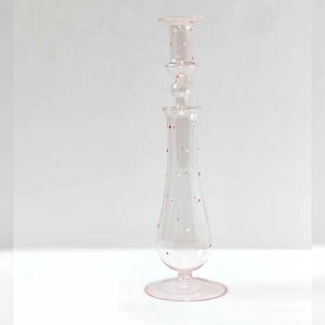 Elegant clear glass candle holder with pink dots and spherical nodes on a slim stem