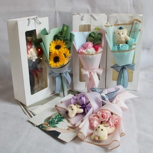 Detail of soap flower gift box with sunflowers, roses and a cute plush bear