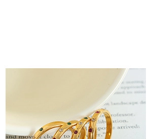 Detailed close-up of gold plated rings featuring colorful zircon stones and fine band