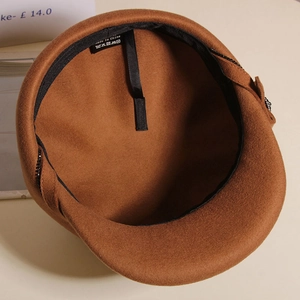 Detailed interior of caramel wool newsboy hat featuring sweatband and adjustable drawstring