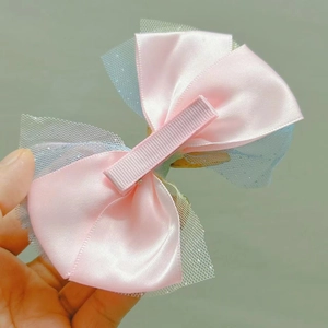 Detail of pink satin and blue glitter tulle bow hair clip with metal alligator fastener