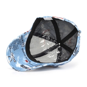 Internal view of newspaper graffiti baseball cap showing 100% polyester fabric detail