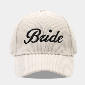 Close-up of Bride black embroidery on beige corduroy wedding baseball cap texture