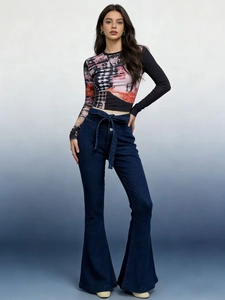 Detail view of high waist flare jeans with matching waist tie and artistic print slim top