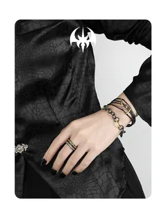 Detail of S925 silver OT buckle bracelet and dark style ring on model with black shirt
