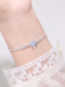 Close-up of floral cubic zirconia silver bracelet with shimmering crystal-paved petals