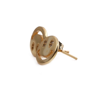 Macro view of gold plated smiley face stud earrings with sparkling crystal eyes