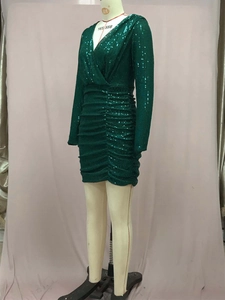 Detail of dark green V-neck long sleeve sequin mini dress with ruched waist texture
